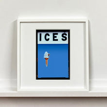 Load image into Gallery viewer, White framed photograph by Richard Heeps.  At the top black letters spell out ICES and below is depicted a 99 icecream cone sitting left of centre against a Baby Blue coloured background.  