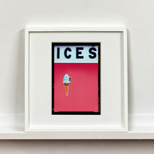 Load image into Gallery viewer, White framed photograph by Richard Heeps.  At the top black letters spell out ICES and below is depicted a 99 icecream cone sitting left of centre against a coral coloured background.  