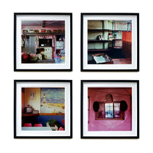 Load image into Gallery viewer, Four Black framed photographs by Richard Heeps. There are four photographs from the Ordinary Places series. The first is of a retro kitchen with an aga, the second one is of an abandoned shoe shop, the third one is in a cafe, the fourth is of some hats sitting around a mirror against a pink wall.