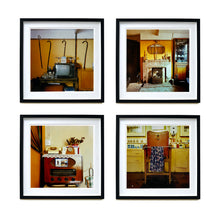 Load image into Gallery viewer, Four black framed photographs by Richard Heeps. From Richard&#39;s series Ordinary Places, the four photos capture vintage indoor scenes. The first one is a television, with 4 walking sticks and a bed pan hanging from the picture rail behind, the second one is a sitting room with a fireplace and candlesticks, the third is a vintage radio with a telephone on top of it, the fourth photo is of a brown leather barbers chair with the colourful cutting gown hanging over a bar on the chair.