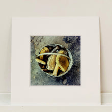 Load image into Gallery viewer, Mounted photograph by Richard Heeps. A bucket with sponges, brushes and wooden handled tools sit in a bucket on a cracked cement floor.