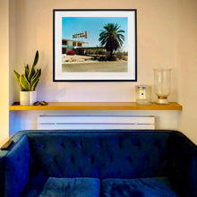Load image into Gallery viewer, In situ photograph by Richard Heeps. A derelict motel office sits on a dusty American road. A large palm tree sits at the front of the office&#39;s walkway.