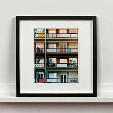 Load image into Gallery viewer, Black framed photograph by Richard Heeps. This is the balconies and balcony doors of 4 floors of flats located on the Rue Dezza. The colours of the walls alternate between red and grey but look different as the light catches them.