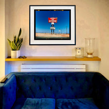 Load image into Gallery viewer, Sundowner Salton Sea California landscape photograph by Richard Heeps framed in black on the living room wall.