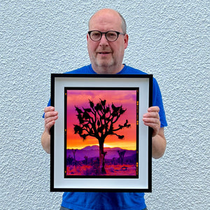 Richard holding Joshua Tree photography artwork framed in black