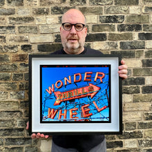 Load image into Gallery viewer, Richard Heeps holding Thrills Coney Island artwork framed in black
