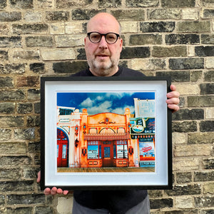 Richard Heeps holding La Belle Femme in the Sun framed in black