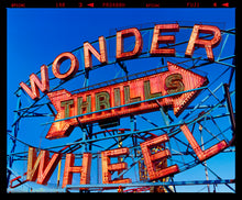 Load image into Gallery viewer, Neon sign for the Wonder Wheel amusement park against a blue sky photograph by Richard Heeps