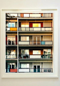 49 Via Dezza, a multi coloured block of flats in Milan, photographed by Richard Heeps at Sunset. 