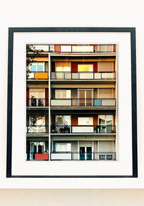 49 Via Dezza, a multi coloured block of flats in Milan, photographed by Richard Heeps at Sunset. 