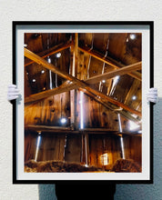 Load image into Gallery viewer, Light breaks through the cracks in the barn on the movie set of Clint Eastwood&#39;s Western film &#39;The Outlaw Josey Wales&#39;. Captured in Kanab, Utah, which was the setting of many Western movies. Photographed by Richard Heeps for his &#39;Dream in Colour&#39; series.