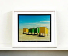 Load image into Gallery viewer, &#39;Beach Lockers&#39; was captured on a glorious spring day in Wildwood, New Jersey. It features bold yellow and green shapes against a beach and bright blue sky. Taken in 2013, this photograph was first executed in Richard&#39;s darkroom in April 2020. Colour is key in Richard&#39;s work, and through the simplicity of this artwork, it really shows. Whilst photographing on the East Coast of America, Richard drew parallels of familiarity to the East Coast of England.