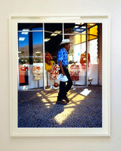 Load image into Gallery viewer, &#39;Boutique&#39; is street portrait, taken in Palm Springs, California. This piece is different from Richard Heeps&#39; usual style, but everything fell into place: the light, the colours, and the man walking through the shot.