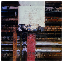 Load image into Gallery viewer, Photograph by Richard Heeps. Warm-toned bricks and metal pipes with a white taped red downpipe at the photo&#39;s centre.  Handwriting on the white tape reads Buzzer Was Ear.
