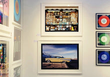Load image into Gallery viewer, &#39;Chevy at the Diner&#39; was photographed in Bisbee, Arizona in 2001 but printed by Richard in his darkroom for the first time more recently in 2018. This cinematic artwork that features a vintage yellow chevy parked up at a Diner will take you on an American road trip. 