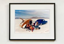 Load image into Gallery viewer, &#39;Christine&#39;s &#39;52 Henry J &amp; teardrop&#39; was captured in Bonneville Salt Flats, Utah, the iconic home of speed. This photograph shows the mountains in the distance meeting and contrasting with the flatness of the salt pan, whilst a pair of retro spectators look out at the speeding cars in the distance.