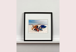 'Christine's '52 Henry J & teardrop' was captured in Bonneville Salt Flats, Utah, the iconic home of speed. This photograph shows the mountains in the distance meeting and contrasting with the flatness of the salt pan, whilst a pair of retro spectators look out at the speeding cars in the distance.