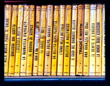 Load image into Gallery viewer, As part of Richard Heeps&#39; series, A Short History of Milan, Delitto A Hollywood features a series of yellow Italian books from a street kiosk. 