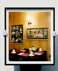 This photograph was taken inside the dining room of the iconic Parry Lodge in Kanab, Utah, which once hosted movie stars of the Western films made in the area. Their faces, cutouts from Life Magazine, adorned the wood panelled walls, which combined with the vintage interior, creates a mid-century cinematic atmosphere. This piece is part of Richard Heeps' 'Dream in Colour' series.