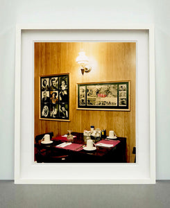 This photograph was taken inside the dining room of the iconic Parry Lodge in Kanab, Utah, which once hosted movie stars of the Western films made in the area. Their faces, cutouts from Life Magazine, adorned the wood panelled walls, which combined with the vintage interior, creates a mid-century cinematic atmosphere. This piece is part of Richard Heeps' 'Dream in Colour' series.