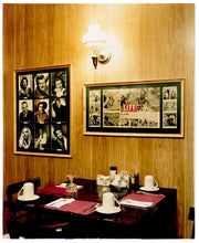 Load image into Gallery viewer, This photograph was taken inside the dining room of the iconic Parry Lodge in Kanab, Utah, which once hosted movie stars of the Western films made in the area. Their faces, cutouts from Life Magazine, adorned the wood panelled walls, which combined with the vintage interior, creates a mid-century cinematic atmosphere. This piece is part of Richard Heeps&#39; &#39;Dream in Colour&#39; series.