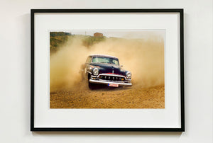 'Donut' shows a classic American car donut driving on a Norfolk beach in the East of England. This photograph was captured at Hemsby Rock and Roll weekend, and is part of Richard Heeps' Man's Ruin' series.