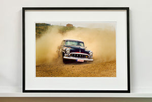'Donut' shows a classic American car donut driving on a Norfolk beach in the East of England. This photograph was captured at Hemsby Rock and Roll weekend, and is part of Richard Heeps' Man's Ruin' series.