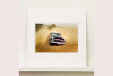 Load image into Gallery viewer, &#39;Donut&#39; shows a classic American car donut driving on a Norfolk beach in the East of England. This photograph was captured at Hemsby Rock and Roll weekend, and is part of Richard Heeps&#39; Man&#39;s Ruin&#39; series.