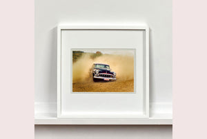 'Donut' shows a classic American car donut driving on a Norfolk beach in the East of England. This photograph was captured at Hemsby Rock and Roll weekend, and is part of Richard Heeps' Man's Ruin' series.