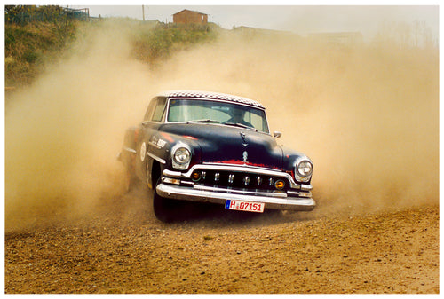 'Donut' shows a classic American car donut driving on a Norfolk beach in the East of England. This photograph was captured at Hemsby Rock and Roll weekend, and is part of Richard Heeps' Man's Ruin' series.