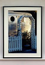 Load image into Gallery viewer, Part of Richard Heeps&#39; &#39;Dream in Colour&#39; series, this photograph features a white picket fence entrance to the Royal Mansion at the Shady Dell Trailer Park in Bisbee. Arizona. 