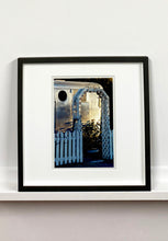 Load image into Gallery viewer, Part of Richard Heeps&#39; &#39;Dream in Colour&#39; series, this photograph features a white picket fence entrance to the Royal Mansion at the Shady Dell Trailer Park in Bisbee. Arizona. 