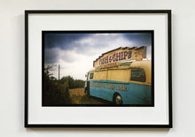 Load image into Gallery viewer, A moody Fenland sky is backdrop to a classic British Fish &amp; Chips Van. The typography and the van itself has a fun fairground feel, contrary to the muted tones of this piece. Part of Richard Heeps series, &#39;A View of the Fens from the Car with Wings&#39;.