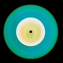 Load image into Gallery viewer, Photograph by Natasha Heidler and Richard Heeps. A Turquoise vinyl record with a yellow and white record label sits on a black background.