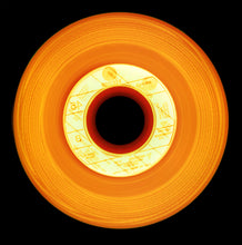 Load image into Gallery viewer, Photograph by Natasha Heidler and Richard Heeps.  An orange vinyl with a light orange record label.  Different tones of orange and red sit in the circular grooves of this record.  This sits on a black background.