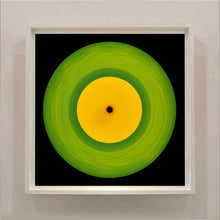 Load image into Gallery viewer, Photograph by Richard Heeps.  A green vinyl record with circular grooves is central with an orange centre sitting on a black background.