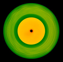 Load image into Gallery viewer, Photograph by Natasha Heidler and Richard Heeps.  A green vinyl record with circular grooves is central with an orange centre sitting on a black background.