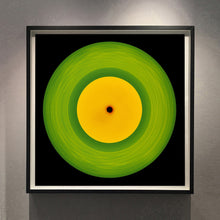 Load image into Gallery viewer, Photograph by Richard Heeps.  A green vinyl record with circular grooves is central with an orange centre sitting on a black background.
