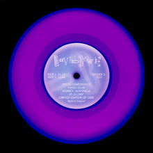 Load image into Gallery viewer, Photograph by Natasha Heidler and Richard Heeps.  A purple vinyl record sits with a record label in the middle with the record details written on it.  There are darker purple circles around the edge groove and in the middle of the record.  The records sits on a black background.
