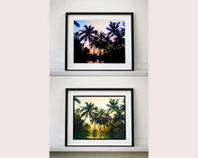 Load image into Gallery viewer, Palm trees stand strong against a setting sun, reflecting gracefully in the water below in this artowork &#39;Vetyver Pool&#39;, taken in Poovar, Kerala in 2013. This gorgeous palm tree print has warming tones and will take you somewhere tropical. Richard Heeps is inspired by films, often referencing them in day to day life and on this journey he had &#39;Apocalypse Now&#39; on his mind.
