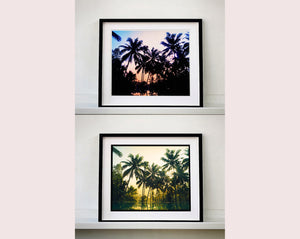 Palm trees stand strong against a setting sun, reflecting gracefully in the water below in this artowork 'Vetyver Pool', taken in Poovar, Kerala in 2013. This gorgeous palm tree print has warming tones and will take you somewhere tropical. Richard Heeps is inspired by films, often referencing them in day to day life and on this journey he had 'Apocalypse Now' on his mind.