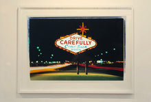 Load image into Gallery viewer, Taken upon leaving Las Vegas, and featured in Richard Heeps&#39; &#39;Dream in Colour&#39; series, this piece features a classic American neon sign, with the Las Vegas lights disappearing into the distance. 