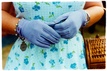 Load image into Gallery viewer, Photograph by Richard Heeps.  Retro lilac gloves are together in front of a blue flowered dress worn by a woman at the Goodwood Revival.  To the side is a wicker basket.