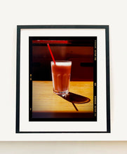 Load image into Gallery viewer, This enticing pink milkshake in a glistening glass was photographed by Richard Heeps in a Clacton-on-Sea cafe. The composition of this artwork is beautifully balanced by the angles of the red straw and shadow. 