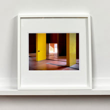 Load image into Gallery viewer, Monte Amiata housing, Gallaratese Quarter, Milan. Yellow brutalist architecture photograph by Richard Heeps framed in white.