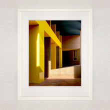 Load image into Gallery viewer, Monte Amiata housing, Gallaratese Quarter, Milan. Yellow brutalist architecture street photography by Richard Heeps framed in white.