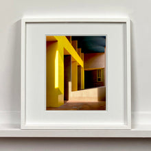 Load image into Gallery viewer, Monte Amiata housing, Gallaratese Quarter, Milan. Yellow brutalist architecture street photography by Richard Heeps framed in white.