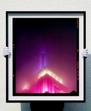 Load image into Gallery viewer, NOMAD I (Film Rebate), New York. Richard Heeps has photographed the iconic Empire State building in the mist. The NOMAD sequence of photographs capture the art deco architecture illuminated by changing colours, and is part of Richard&#39;s street photography portfolio which depict the colour, fabric and structure of cities with distinct style. This 6x7 format edition is bordered by the Kodak film rebate. 