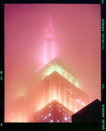 'NOMAD III (Film Rebate)', New York. Richard Heeps has photographed the iconic Empire State building in the mist. The NOMAD sequence of photographs capture the art deco architecture illuminated by changing colours, and is part of Richard's street photography portfolio which depict the colour, fabric and structure of cities with distinct style. This 6x7 format edition is bordered by the Kodak film rebate.