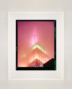 'NOMAD III (Film Rebate)', New York. Richard Heeps has photographed the iconic Empire State building in the mist. The NOMAD sequence of photographs capture the art deco architecture illuminated by changing colours, and is part of Richard's street photography portfolio which depict the colour, fabric and structure of cities with distinct style. This 6x7 format edition is bordered by the Kodak film rebate.